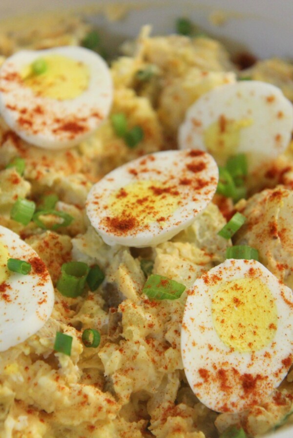 potato and egg salad in a white bowl.