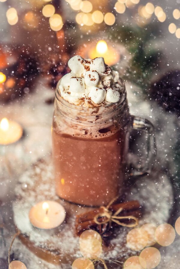 hot chocolate in a glass mug with marshmallows on top.