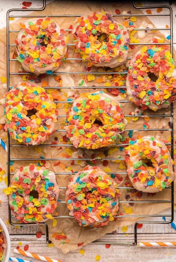 8 fruity pebble donuts on a wire rack