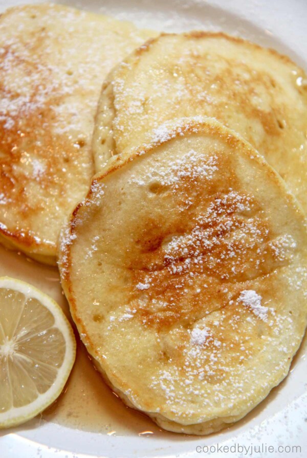 lemon ricotta pancakes with syrup and lemon slices
