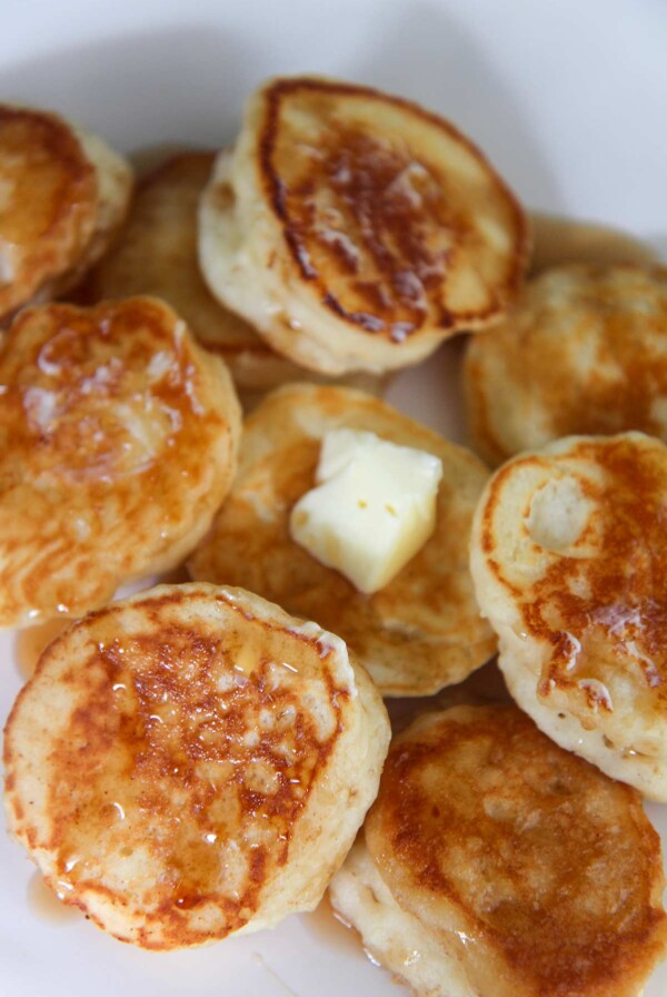 silver dollar pancakes with butter and syrup.