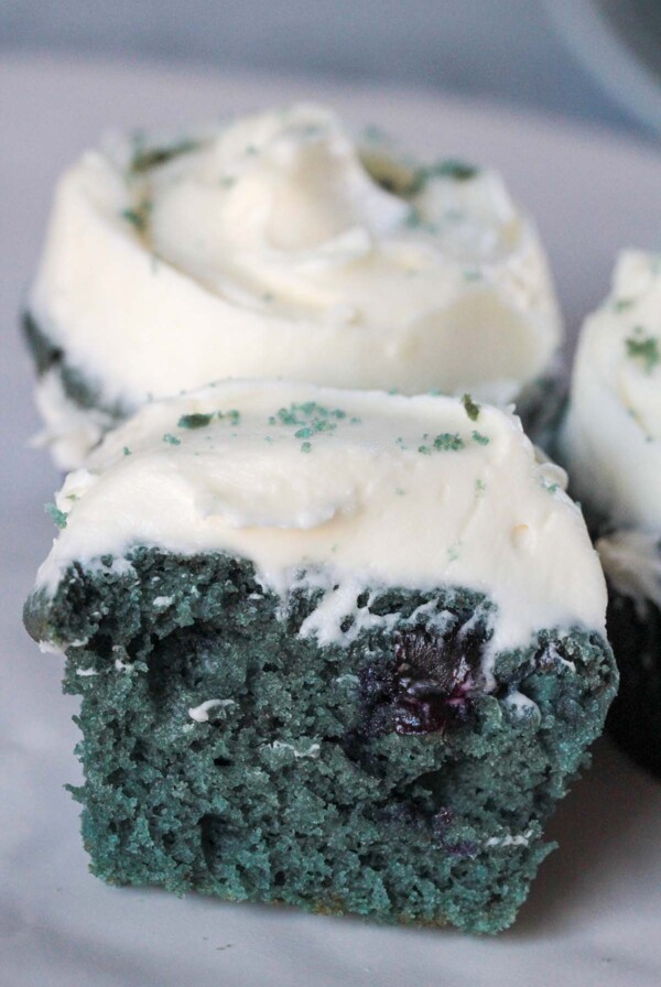 the inside of a blue velvet cupcake with cream cheese frosting