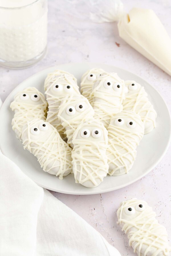 nutter butter mummies on a white plate.