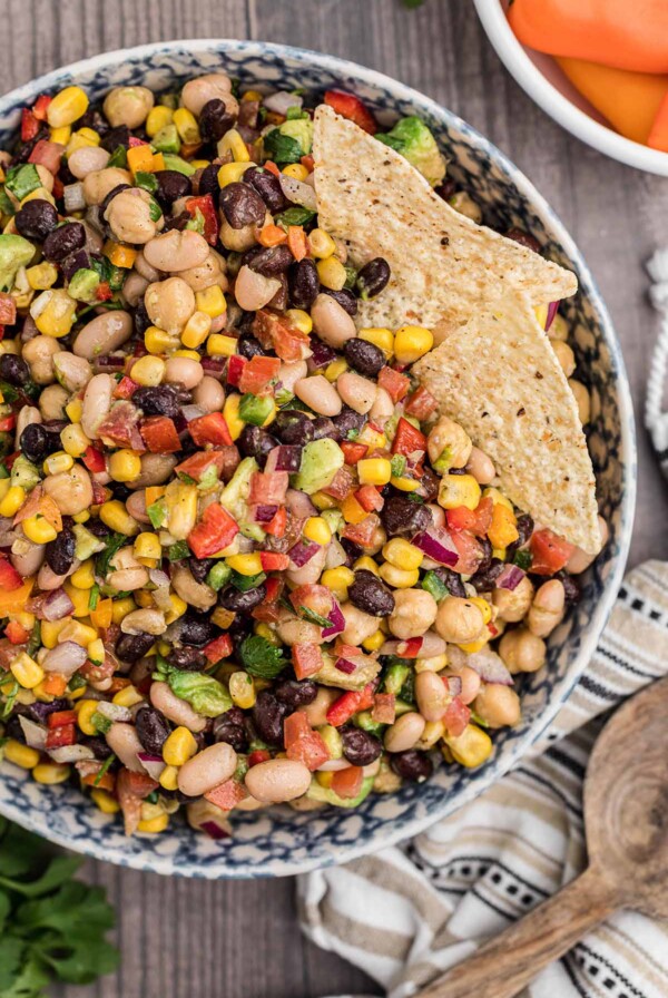 cowboy caviar in a bowl with two tortilla chips.