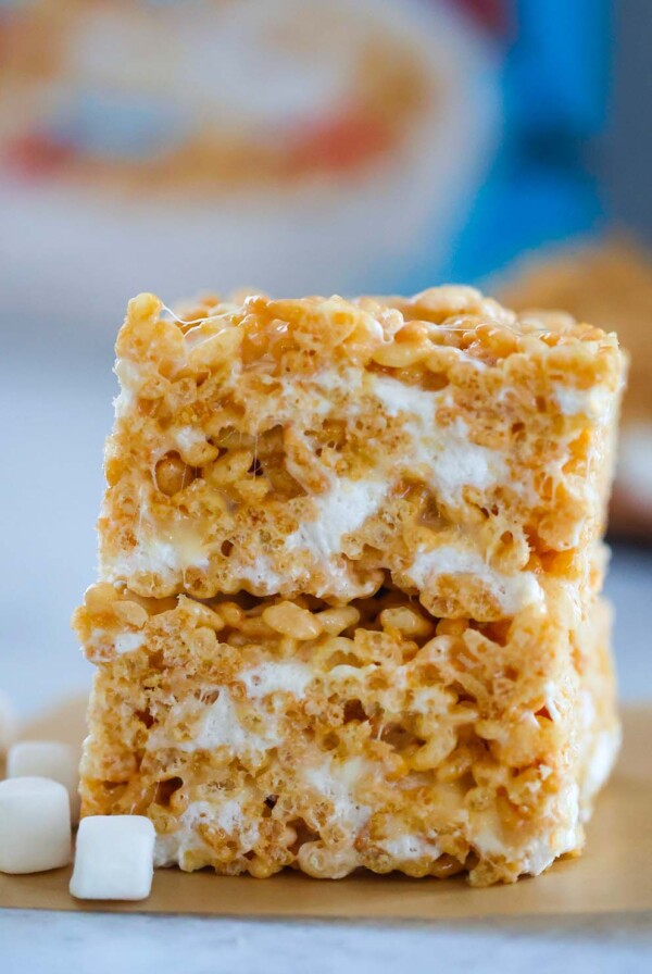 two rice krispie treats stacked with marshmallows on the side.