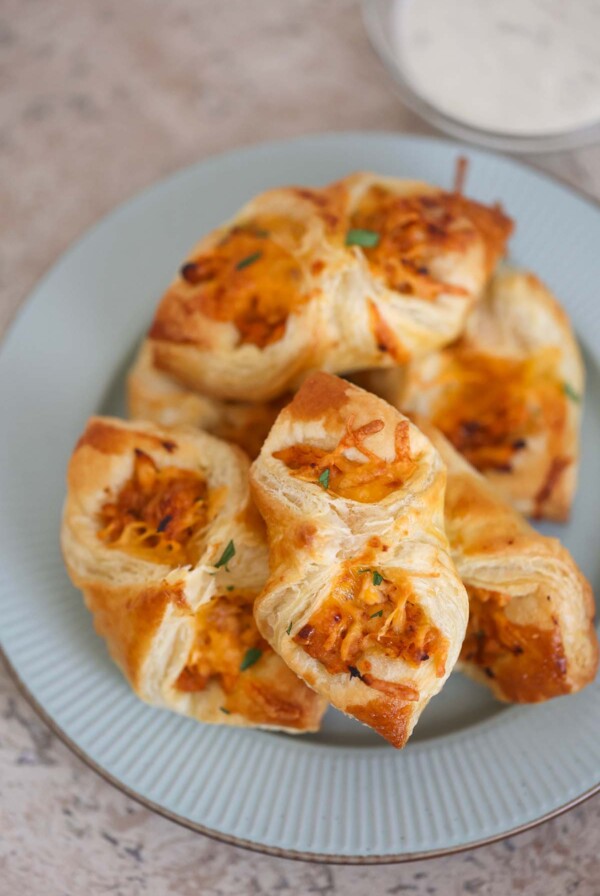 BBQ chicken pastry puffs on a plate with ranch on the side.