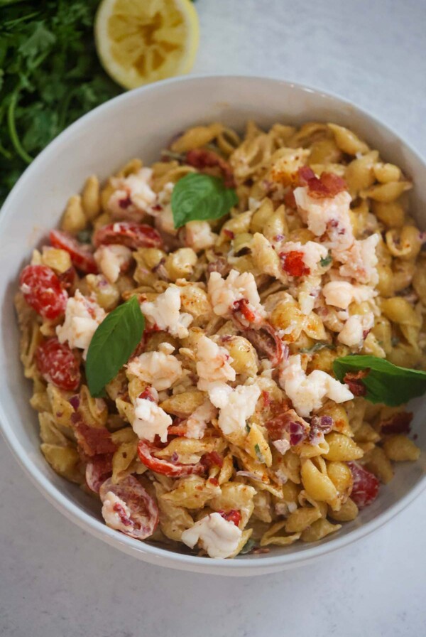 Lobster pasta salad with fresh basil on top.