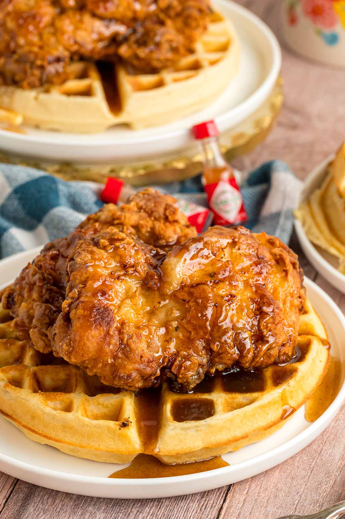 Southern fried chicken and waffles on a white plate. 