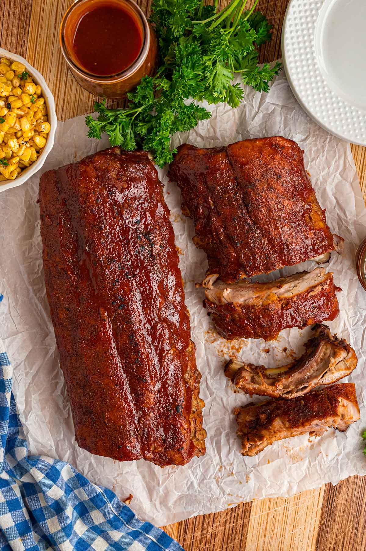 Two pork rib slabs with bbq sauce on top. 