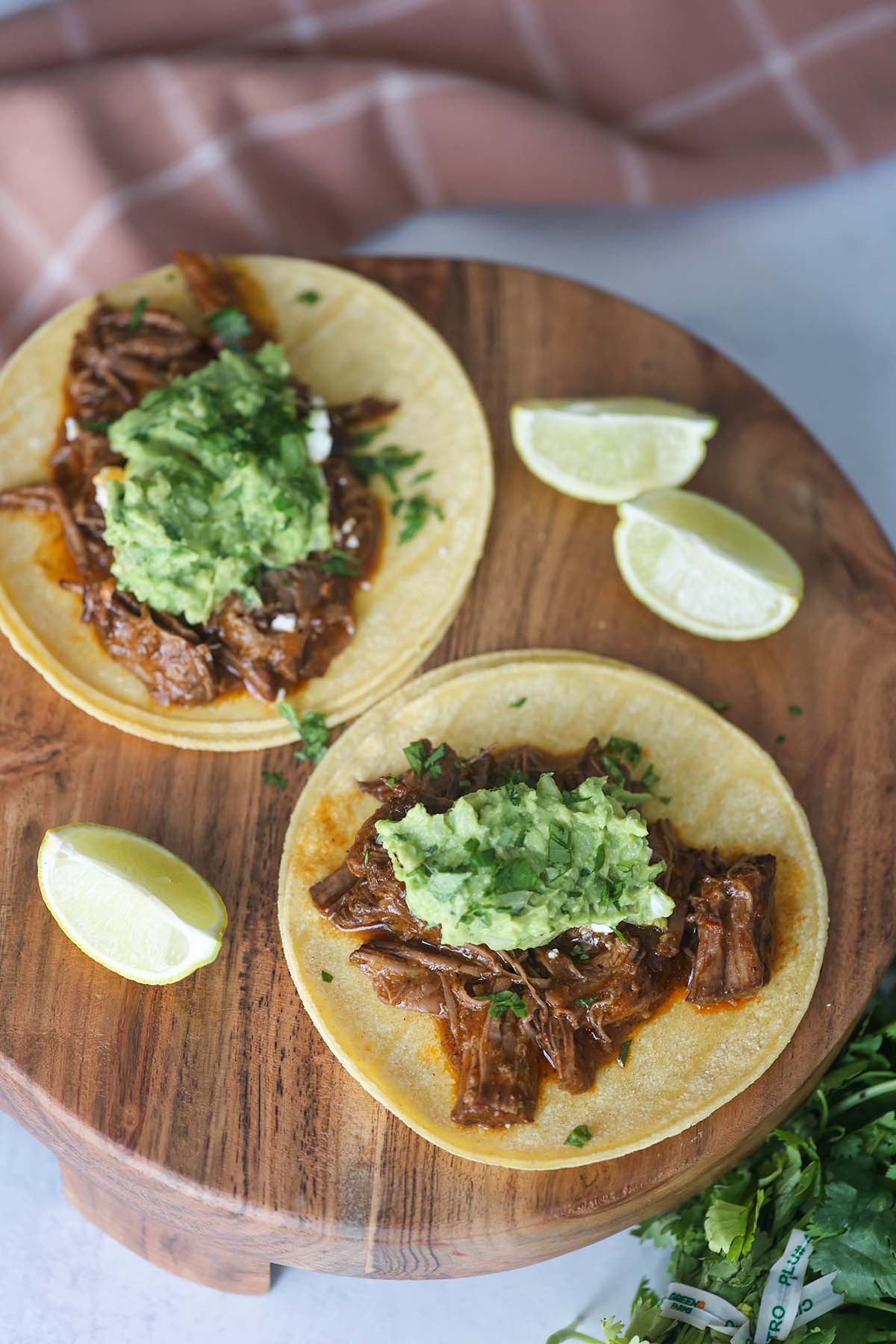 two shredded beef tacos up close. 