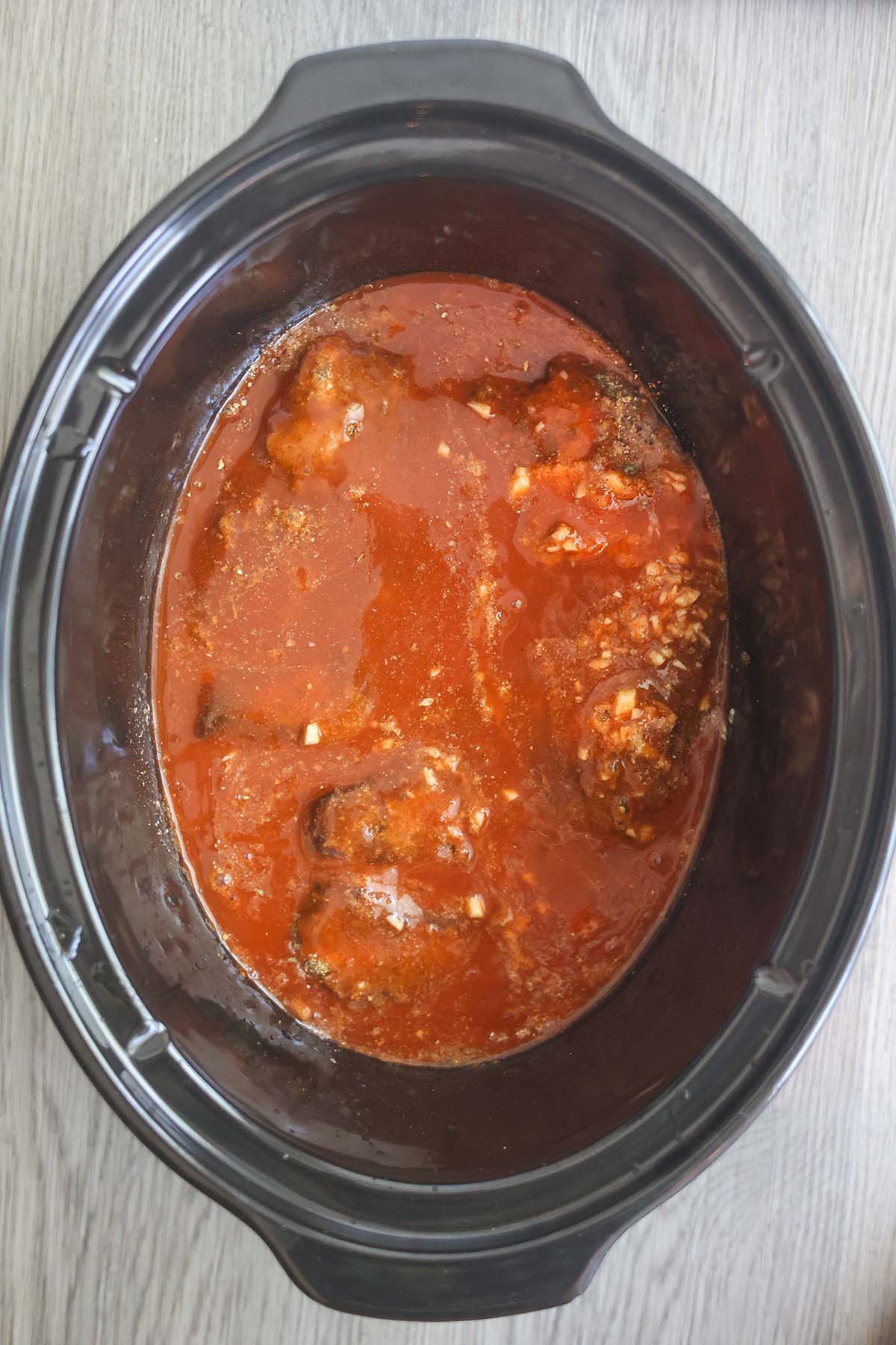 beef, enchilada sauce, and spices in a slow cooker. 