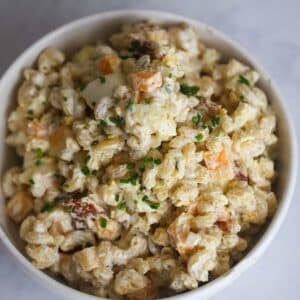 creamy bacon ranch pasta salad in a white bowl.