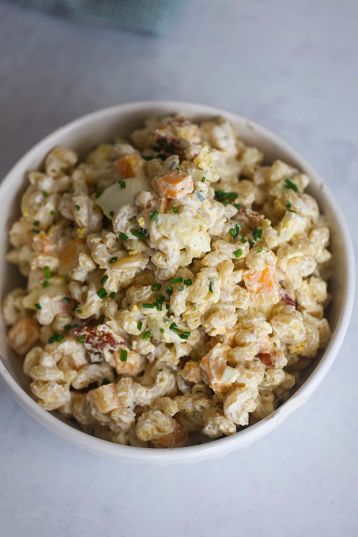 creamy bacon ranch pasta salad in a white bowl.